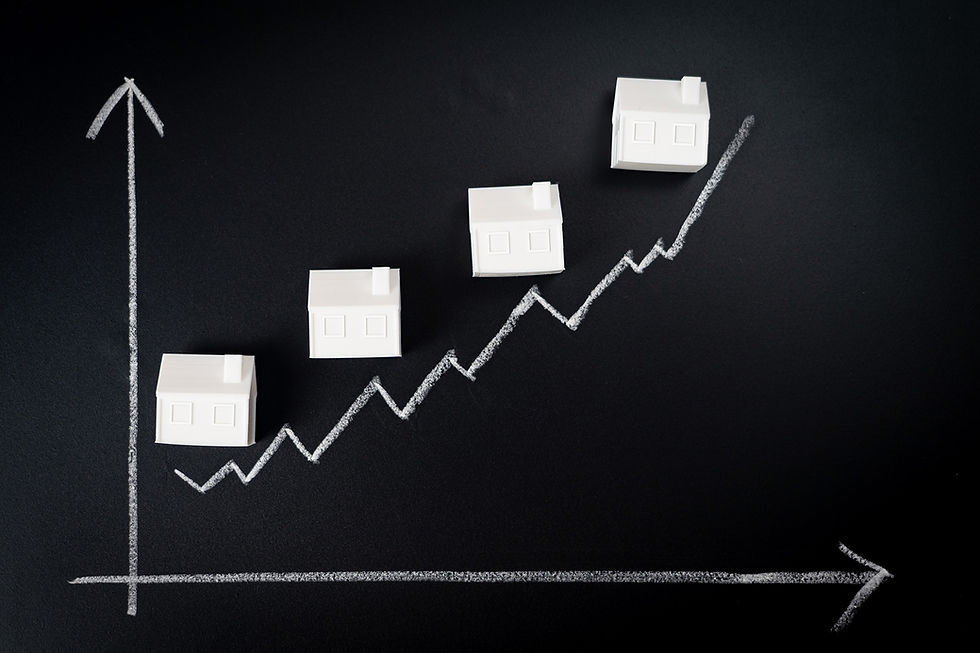 White houses placed along an upward chalk graph on a black background, symbolising rising rebuild cost trends.