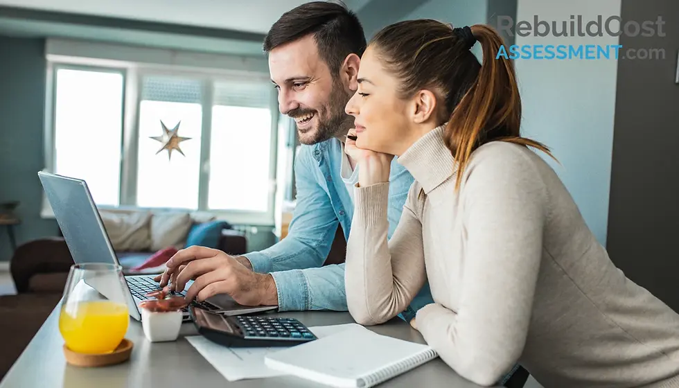 Couple using a laptop to research building insurance when buying a house, focusing on financial decisions.