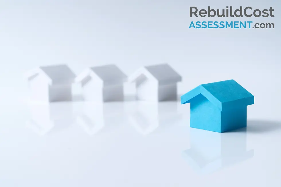 A blue model house in focus with three white houses blurred in the background. Symbolising the lack of accurately insured houses in the UK. RebuildCostASSESSMENT.com logo in top right.
